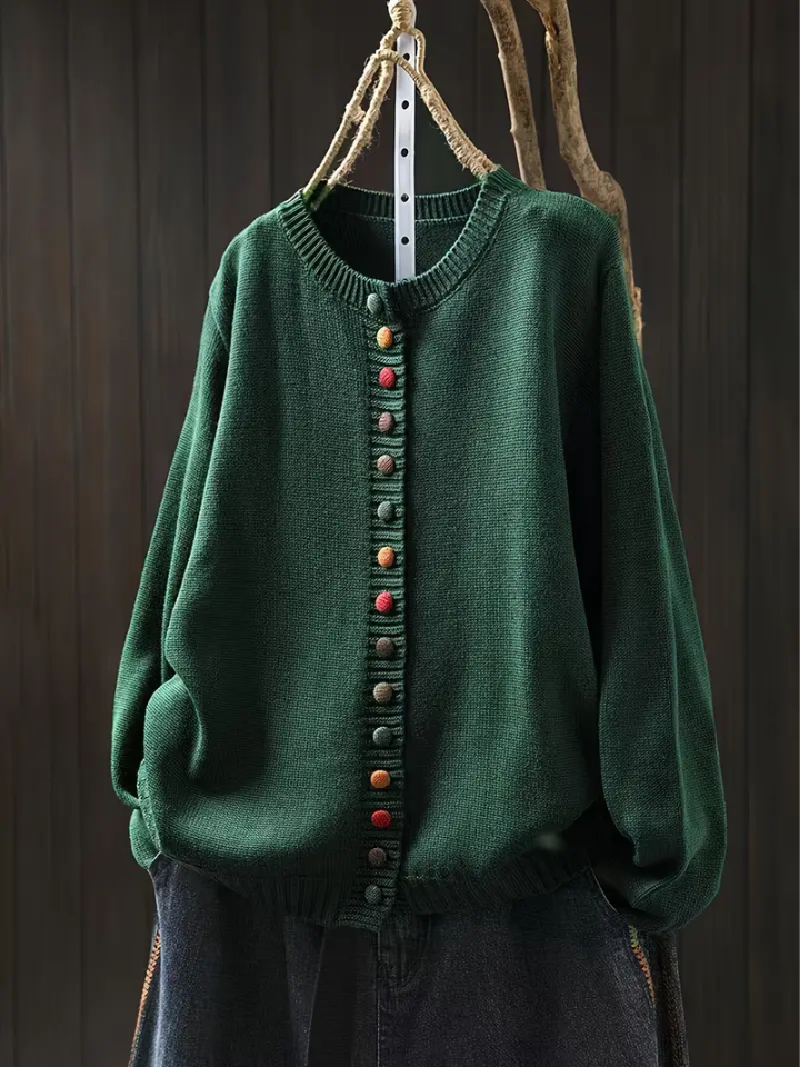 Green knit cardigan with round neckline, multicolor button-front placket and long sleeves.