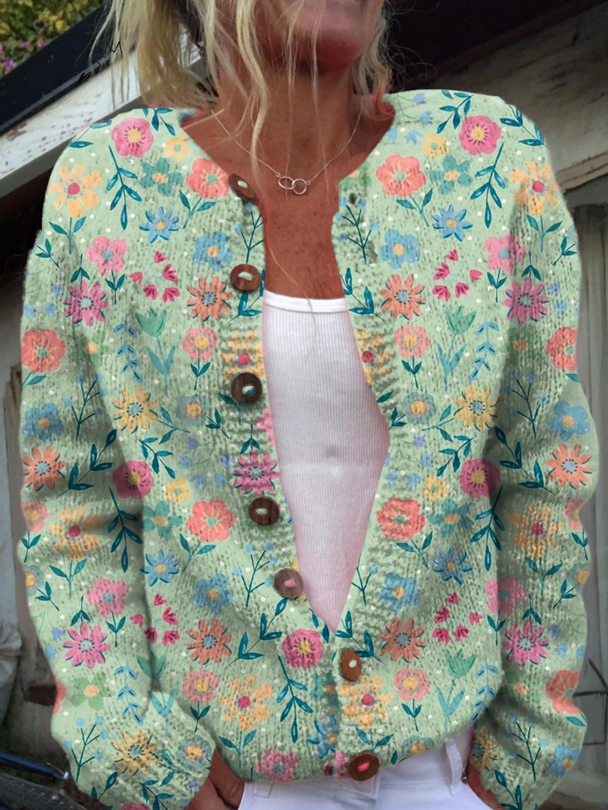 Light blue floral button pullover with V-neck, long sleeves, and brown front buttons