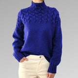 Women's cable-knit turtleneck sweater, royal blue with raised cable pattern.