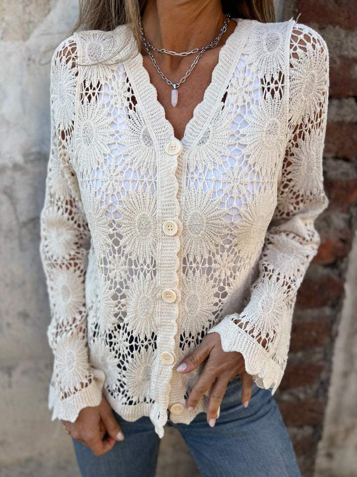 White lace cardigan with V-neck, button front, and long sleeves; openwork floral knit