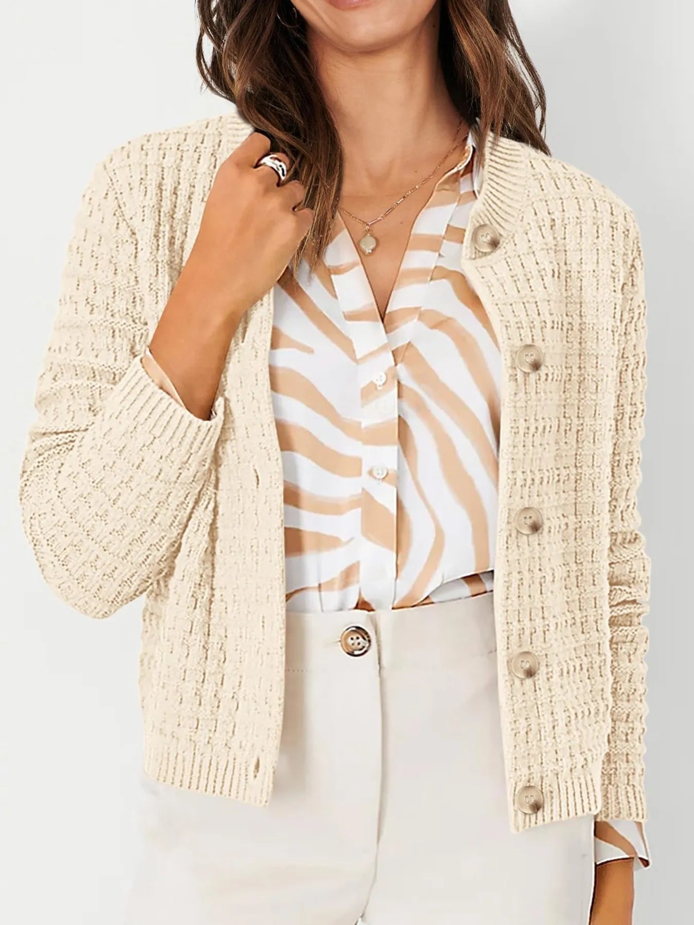 Cream knit cardigan with button front, textured knit, and ribbed cuffs, front view