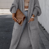 Light gray long knit cardigan with open front, long sleeves, and side pockets