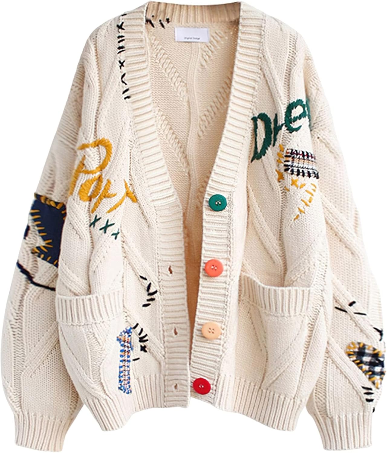 Beige knit V-neck vest with button front, patchwork motifs, and two front pockets