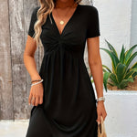 Black short-sleeve dress with twisted V-neck and gathered waist detail