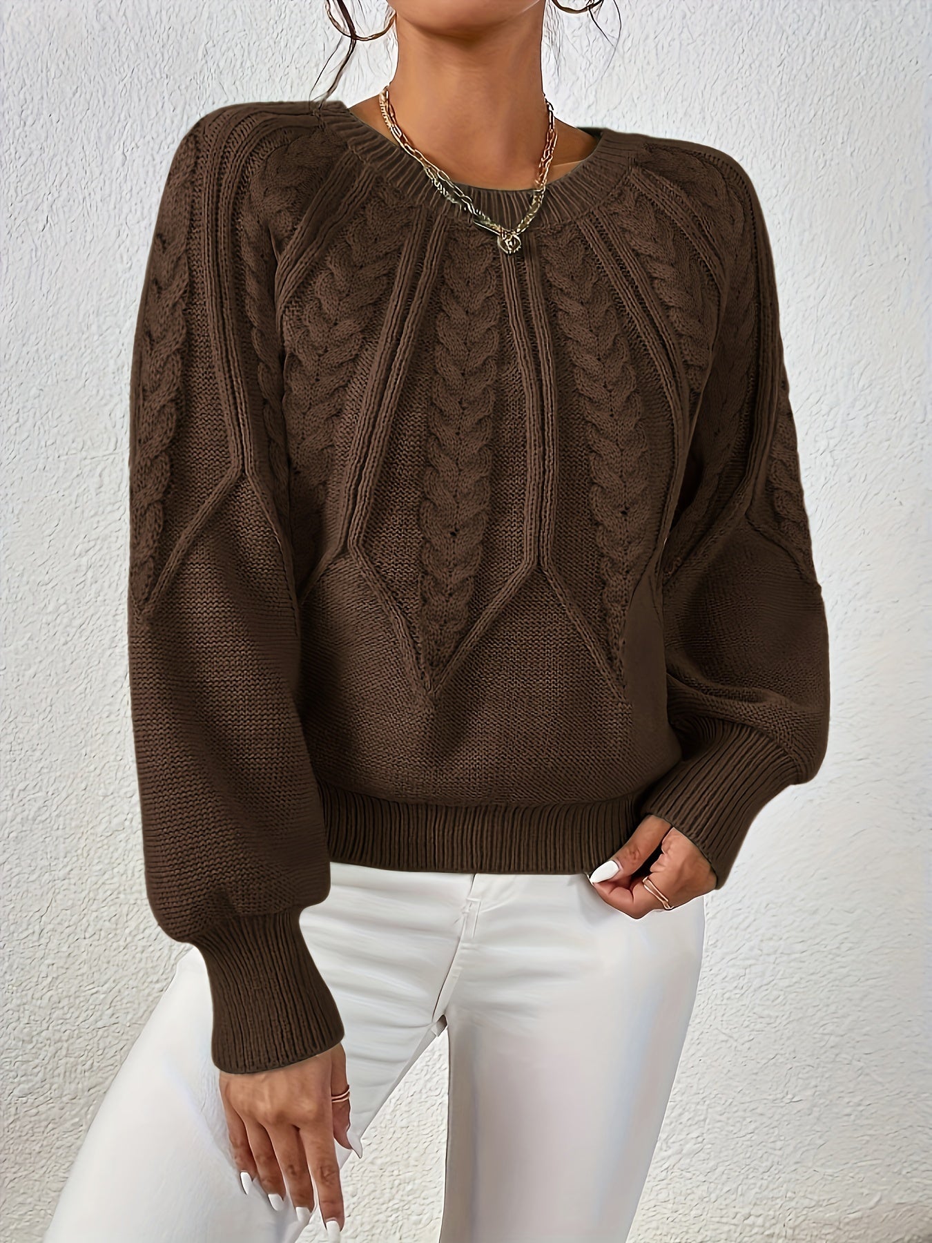 Dark brown cable-knit long-sleeve pullover with half-zip neckline and ribbed cuffs