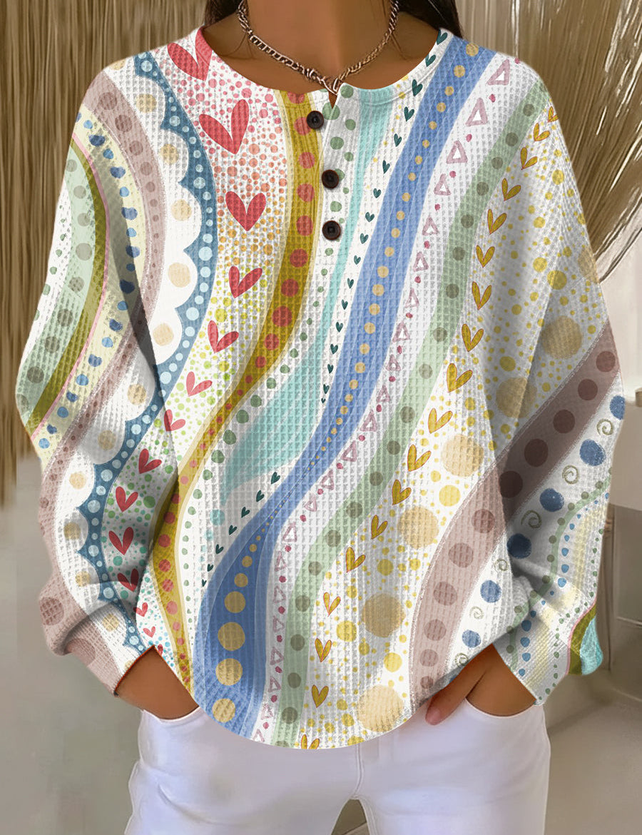 Colorful patterned pullover sweater, long sleeves, button-front henley style