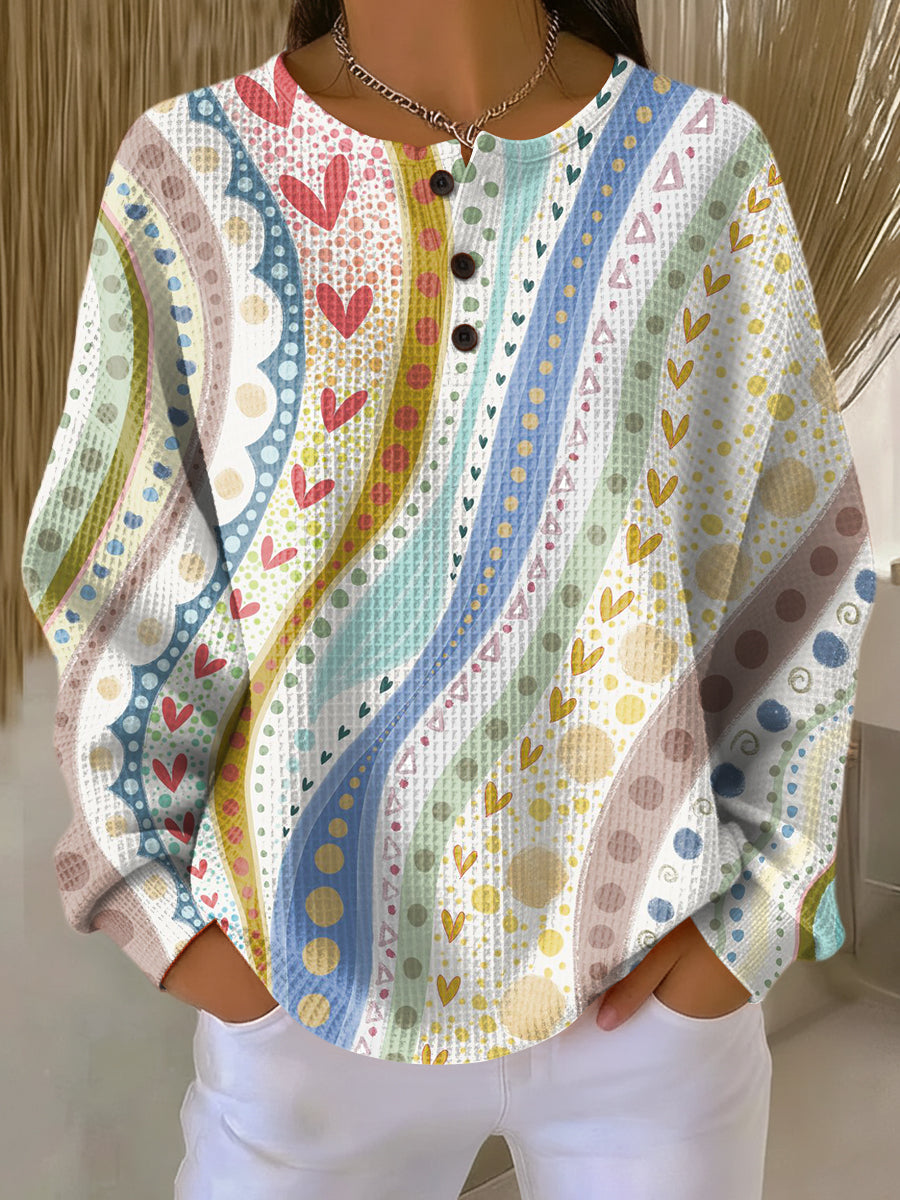 Colorful patterned pullover sweater, long sleeves, button-front henley style