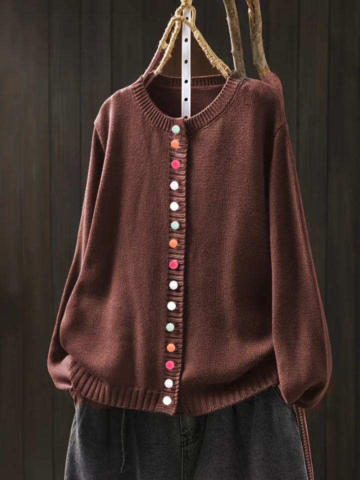 Rust-brown knit cardigan with round neckline and multicolor button-front placket.