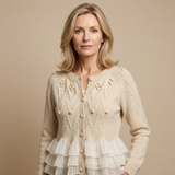 Cream ruffle-front cardigan with button placket, textured bobble knit, and tiered hem