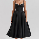 Black fitted corset bodice dress with thin straps and full flared midi skirt