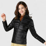 Black quilted puffer jacket with zip front and stand collar, model smiling