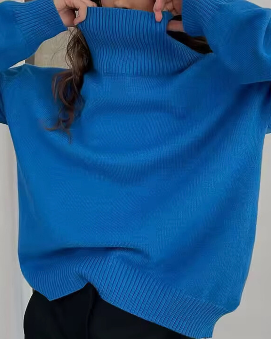 Oversized bright blue turtleneck knit sweater with ribbed collar and cuffs