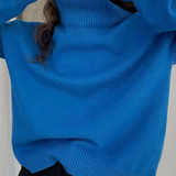 Oversized bright blue turtleneck knit sweater with ribbed collar and cuffs