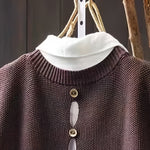 Brown knit sleeveless cardigan with cowl neck and row of round gold-tone buttons
