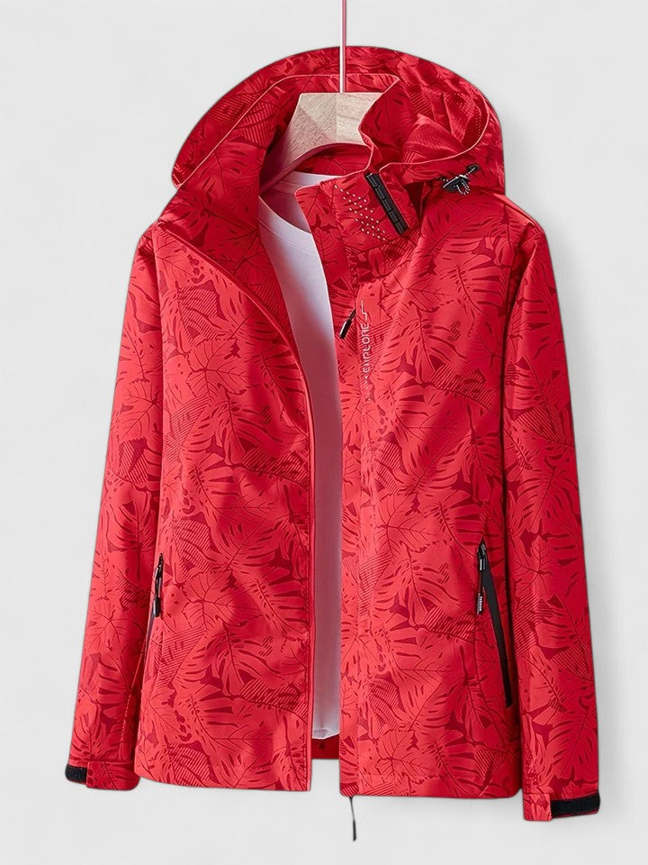 Red hooded jacket with front zipper and stand collar, leafy pattern all over