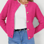 Pink textured knit cardigan with button front and long sleeves, waffle-like texture