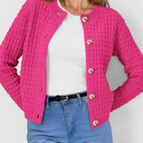 Pink textured knit cardigan with button front and long sleeves, waffle-like texture