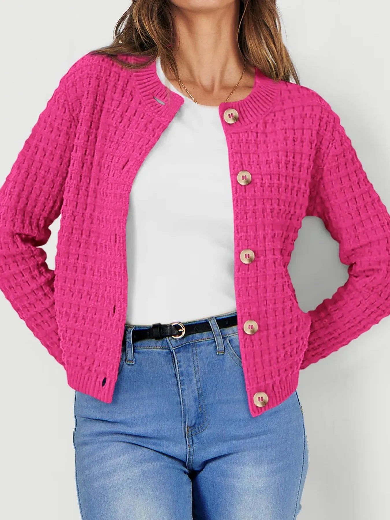Pink textured knit cardigan with button front and long sleeves, waffle-like texture