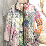 Women's quilted zip-up jacket with multicolor floral patchwork and dark trim