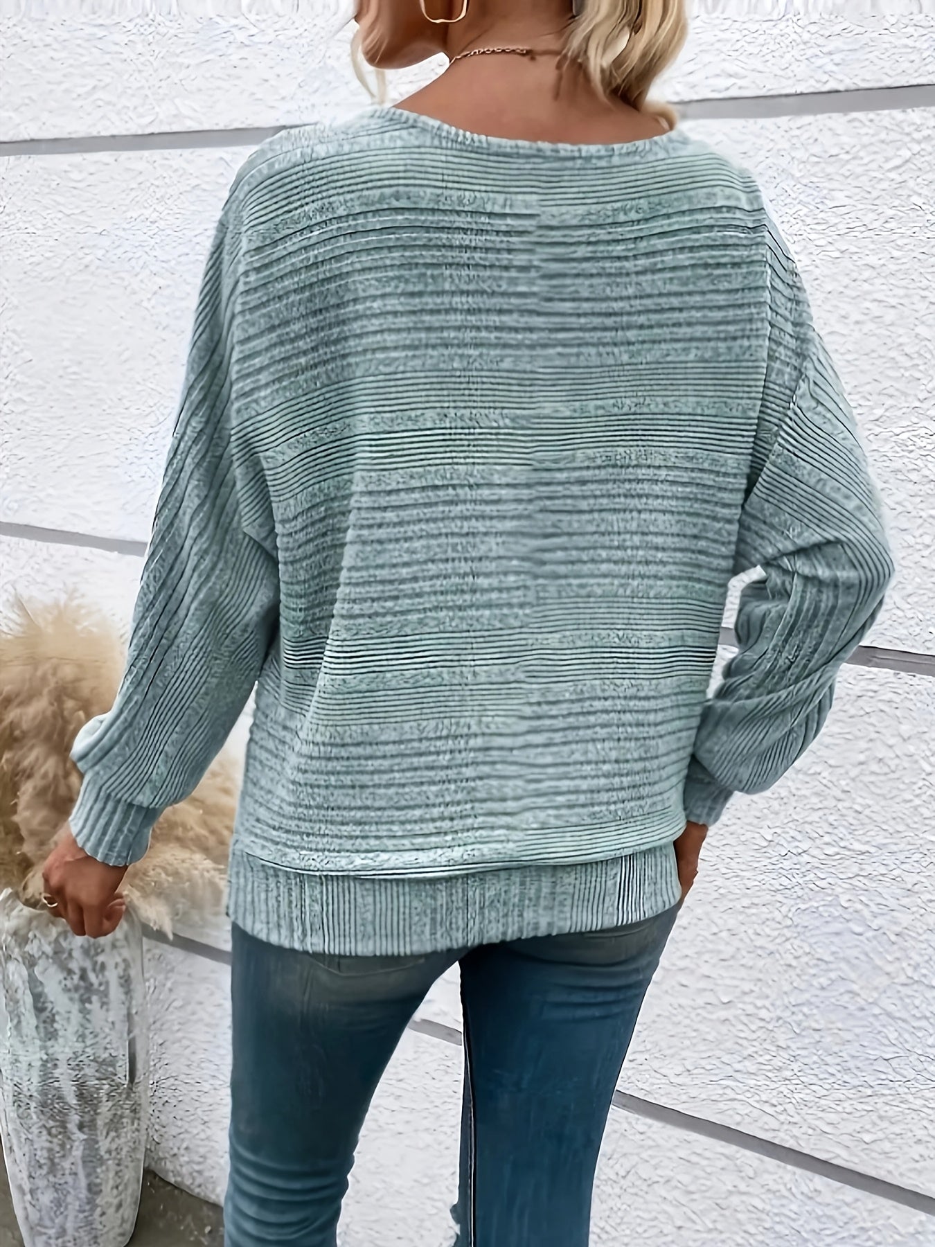 Light green striped knit pullover with batwing sleeves, ribbed cuffs and hem
