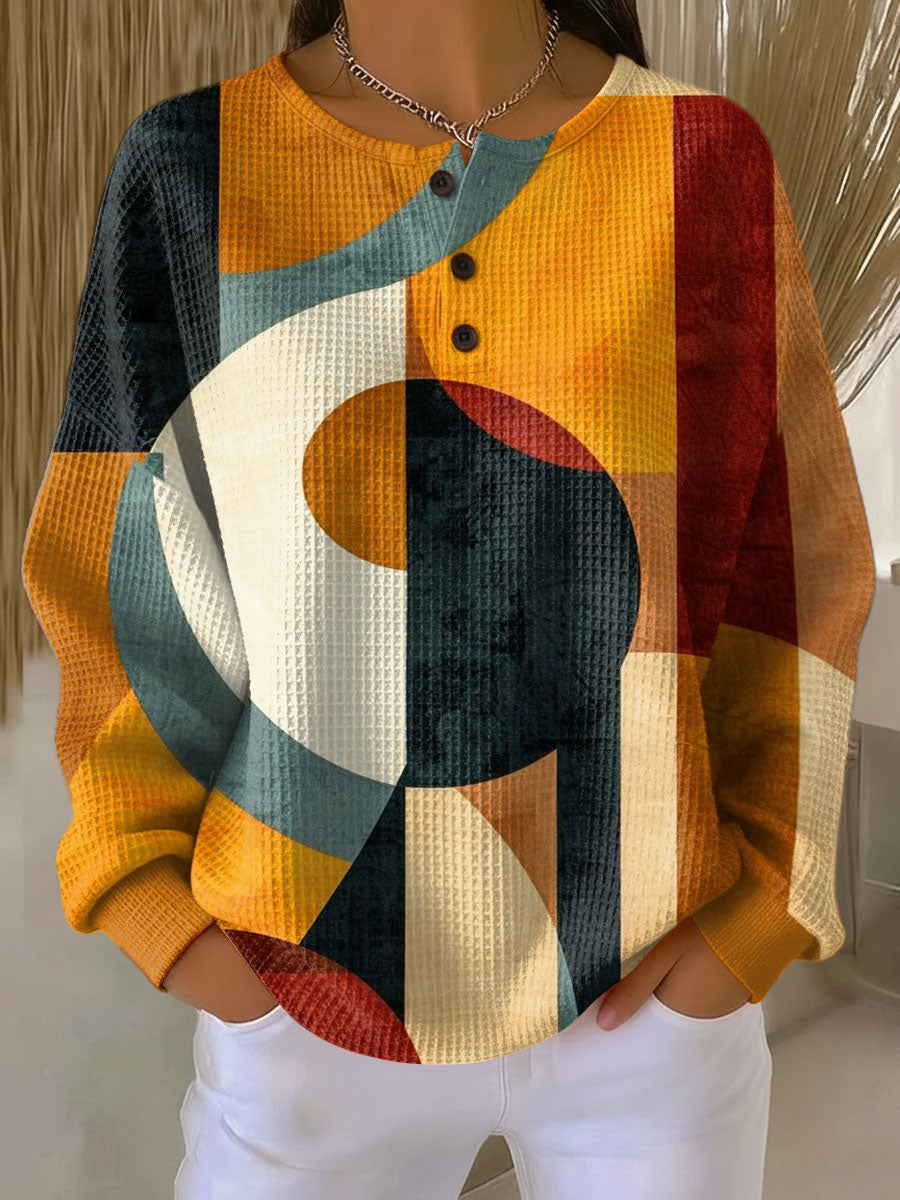 Orange geometric-pattern waffle-knit pullover sweater with button placket and long sleeves