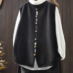 Black sleeveless knit cardigan with long button placket detail and ribbed hem