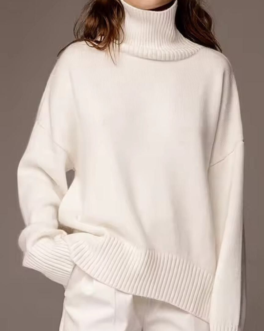 Oversized white turtleneck knit sweater with ribbed collar and drop sleeves