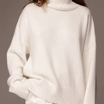 Oversized white turtleneck knit sweater with ribbed collar and drop sleeves
