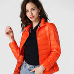 Orange quilted puffer jacket with zip front and stand collar, model standing