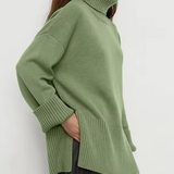 Green knit turtleneck sweater with long sleeves, ribbed collar, and cuffs