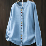 Light blue cardigan sweater with multicolor button front and ribbed crew neckline