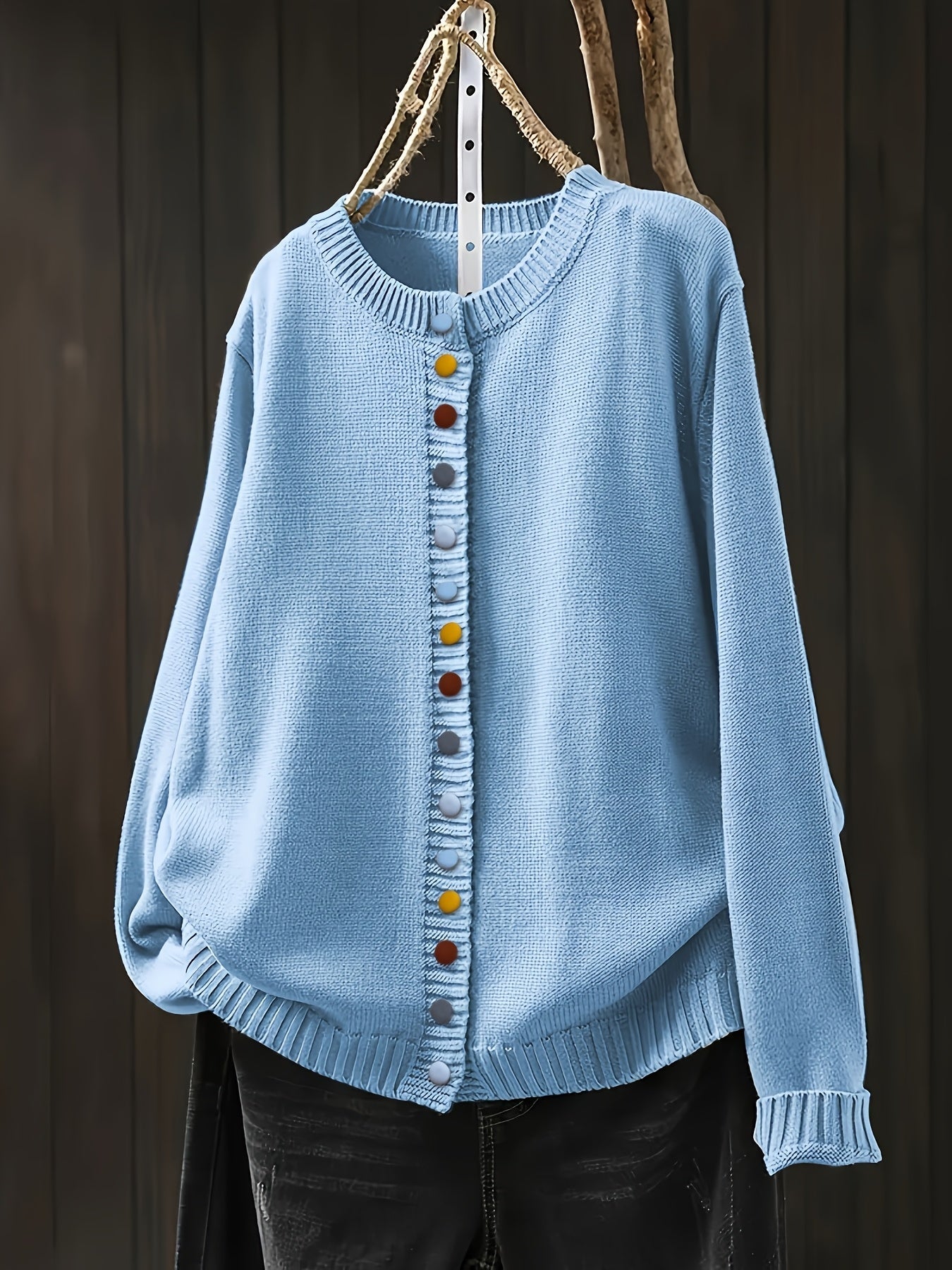Light blue cardigan sweater with multicolor button front and ribbed crew neckline