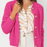 Pink textured knit cardigan with button front and long sleeves, ribbed cuffs