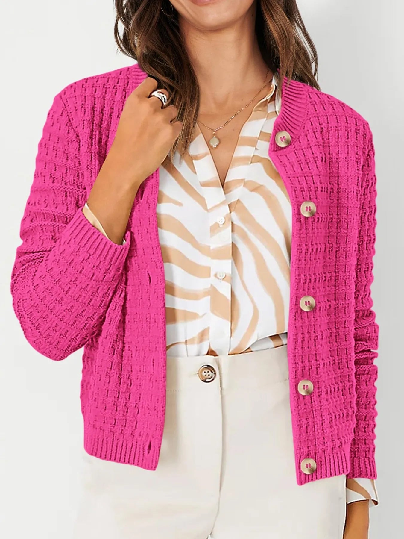Pink textured knit cardigan with button front and long sleeves, ribbed cuffs