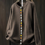 Brown cardigan sweater with multicolor button front and ribbed crew neckline