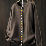Brown cardigan sweater with multicolor button front and ribbed crew neckline