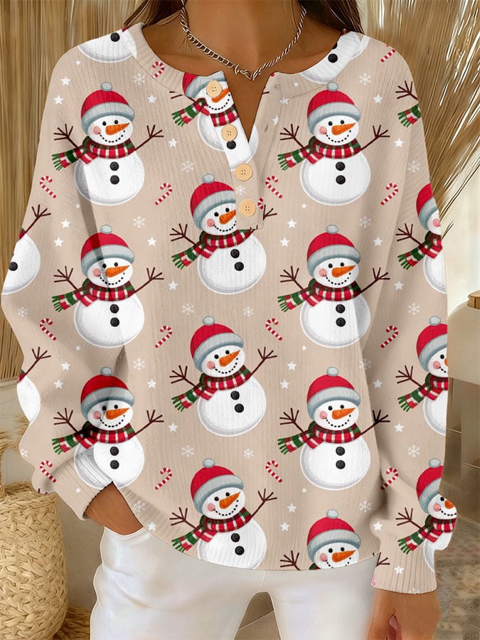 Cream long-sleeve button-front top with allover snowman print and crew neckline.