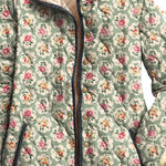 Floral hooded vintage jacket close-up with button placket and beige hood lining