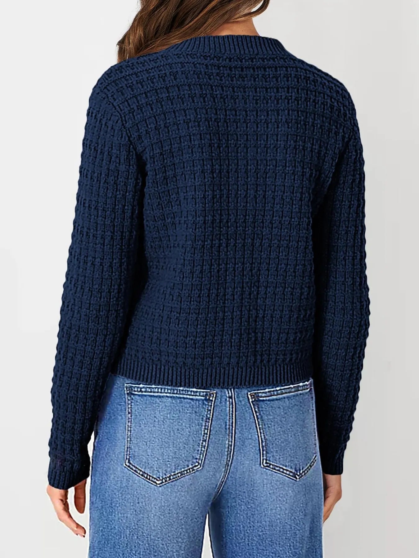 Navy textured knit cardigan, back view with long sleeves and ribbed hem