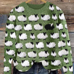 Festive knit sweater with green base and white cloud cow print, crew neck, long sleeves