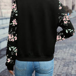 Black zip-up jacket with floral print sleeves, back view