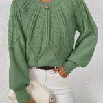 Green cable-knit long-sleeve pullover with half-zip neckline and ribbed cuffs