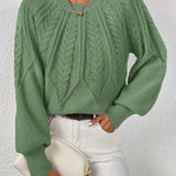 Green cable-knit long-sleeve pullover with half-zip neckline and ribbed cuffs