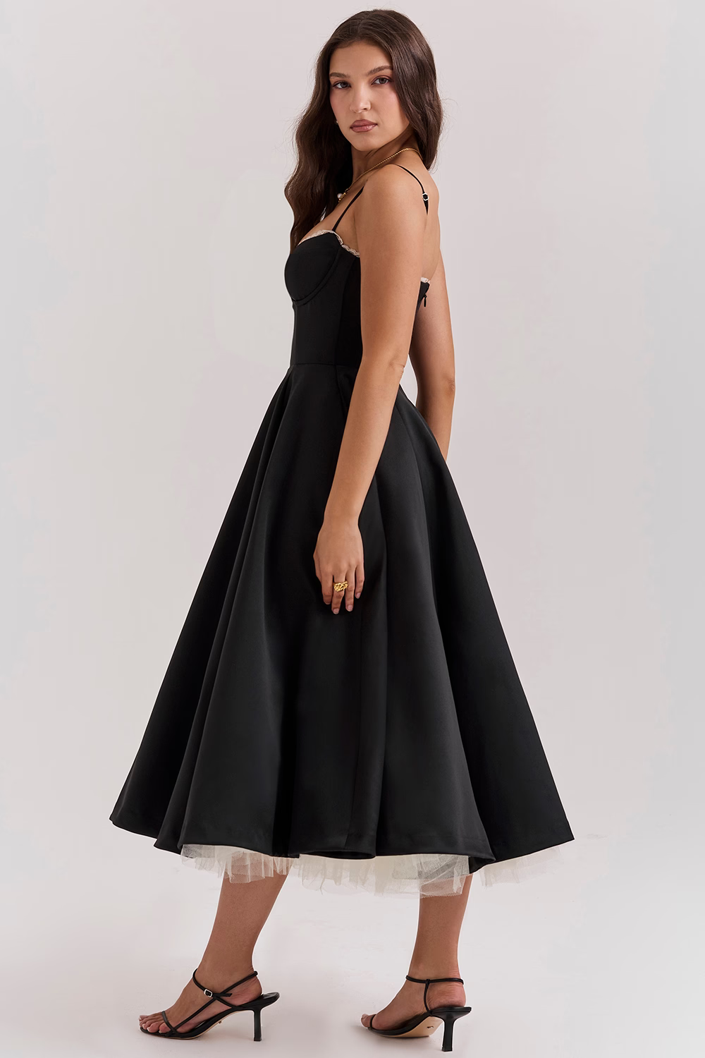 Women's black corset slimming dress with flared skirt and tulle underskirt, side view