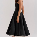 Women's black corset slimming dress with flared skirt and tulle underskirt, side view