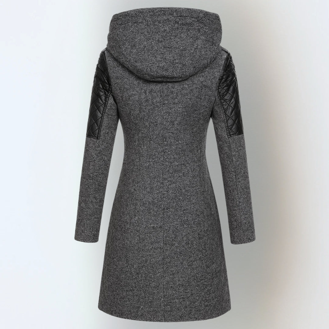 Women’s winter parka coat in dark gray, back view, quilted sleeves, attached hood.