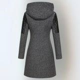 Women’s winter parka coat in dark gray, back view, quilted sleeves, attached hood.