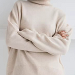 Oversized cream turtleneck knit sweater with ribbed hem and long sleeves
