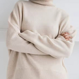 Oversized cream turtleneck knit sweater with ribbed hem and long sleeves