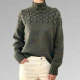 Women's cable-knit turtleneck sweater, olive green textured front and sleeves.